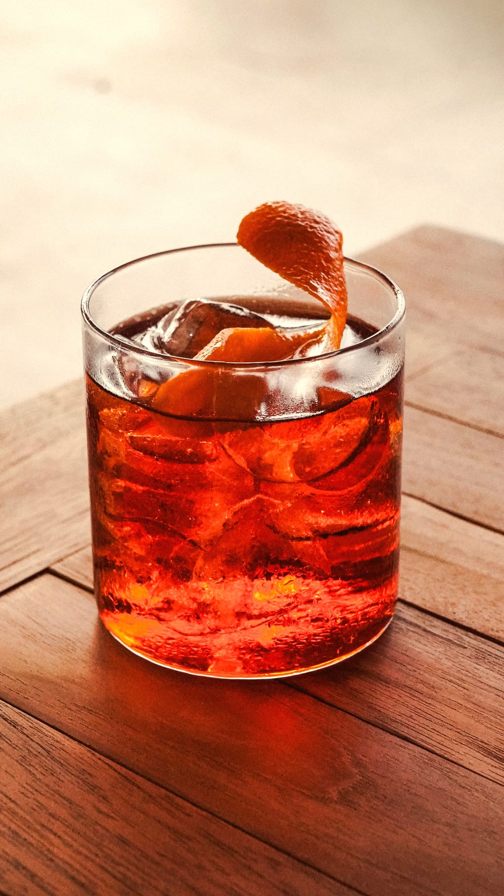A citrus cocktail with a striped straw