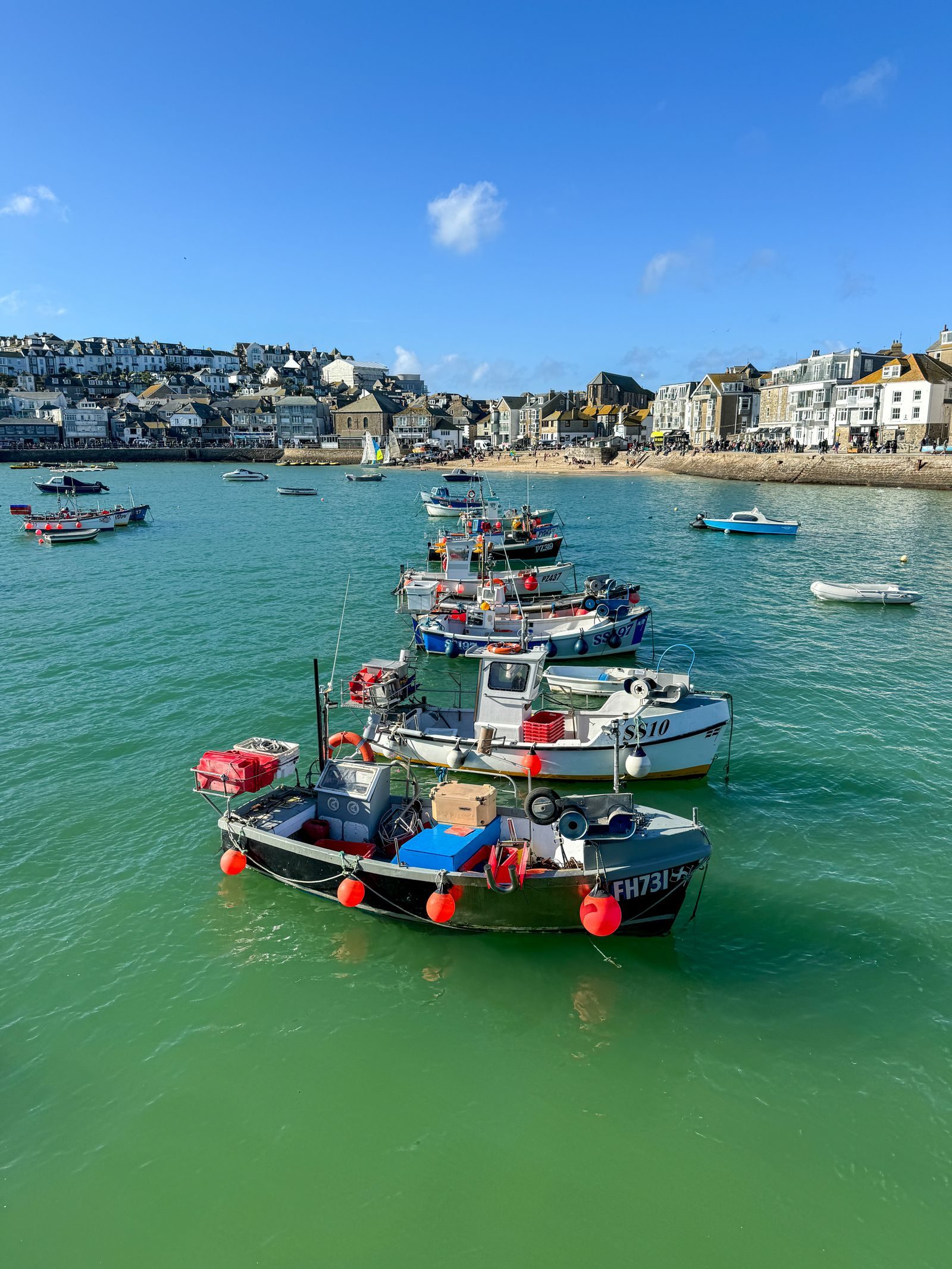 Colourful fishing boats in the turquoise harbour at St Ives, Cornwall