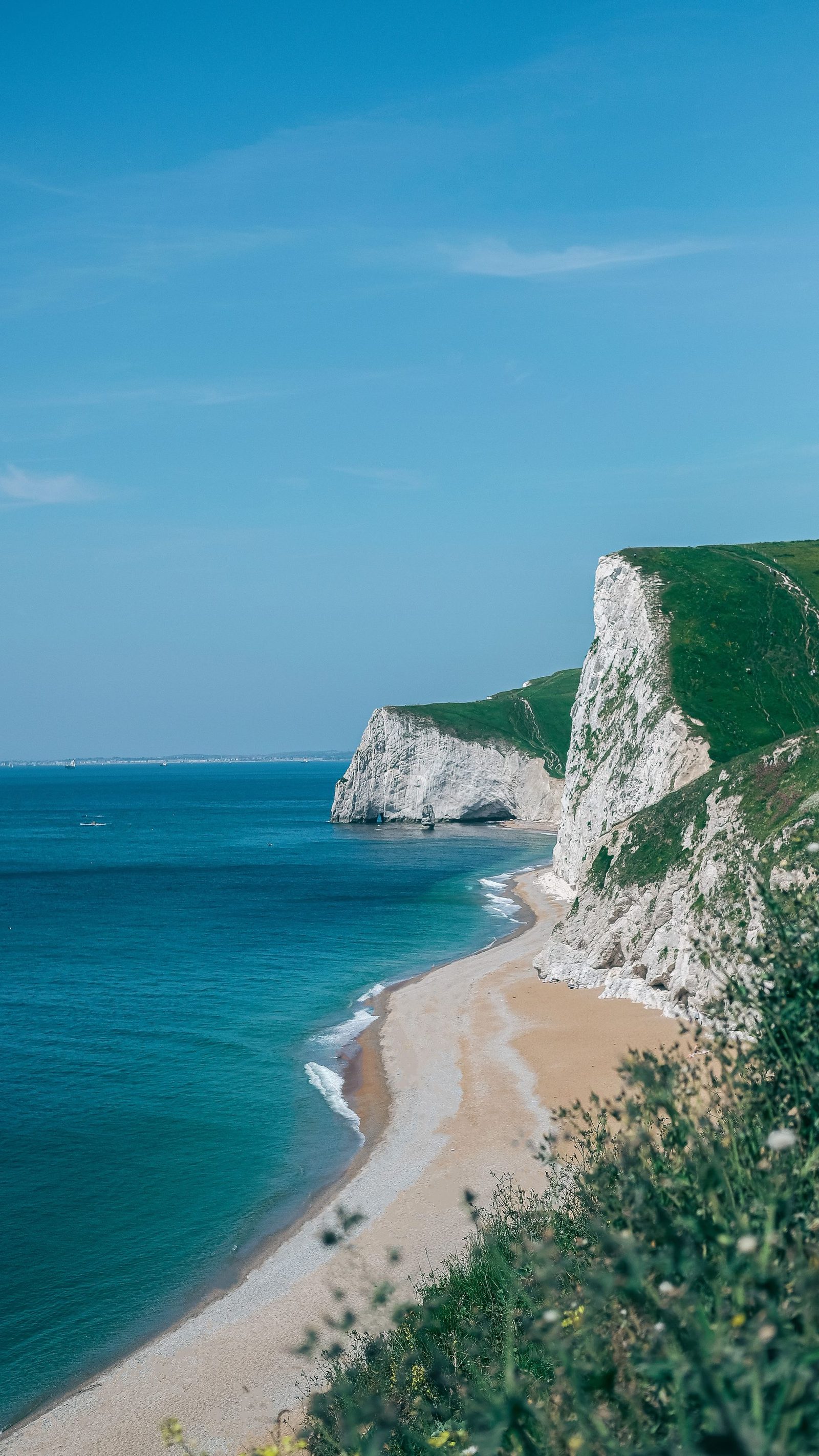 White chalk cliffs and a curving beach on the Jurassic Coast in Dorset