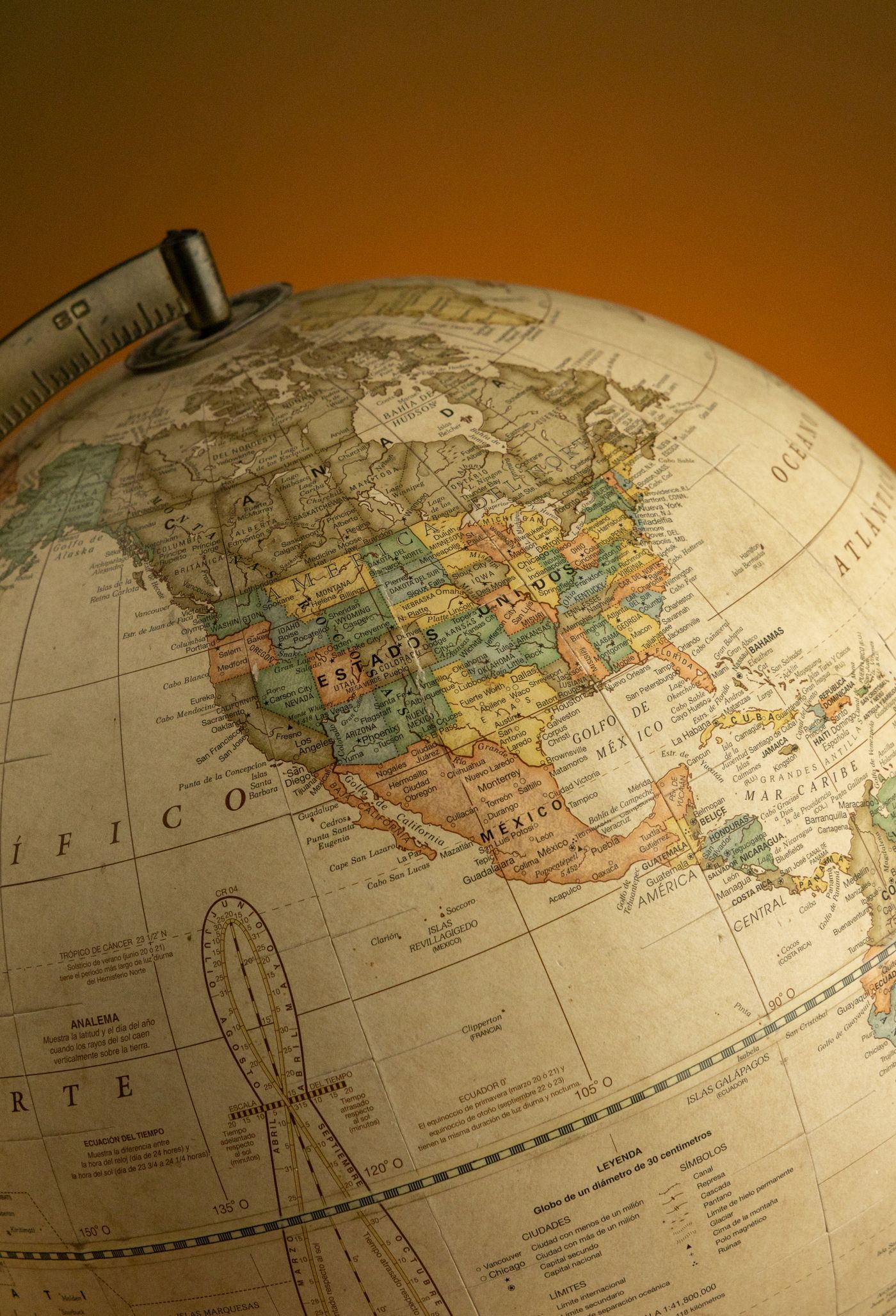 A close-up of a vintage globe highlighting North America, captured with warm lighting