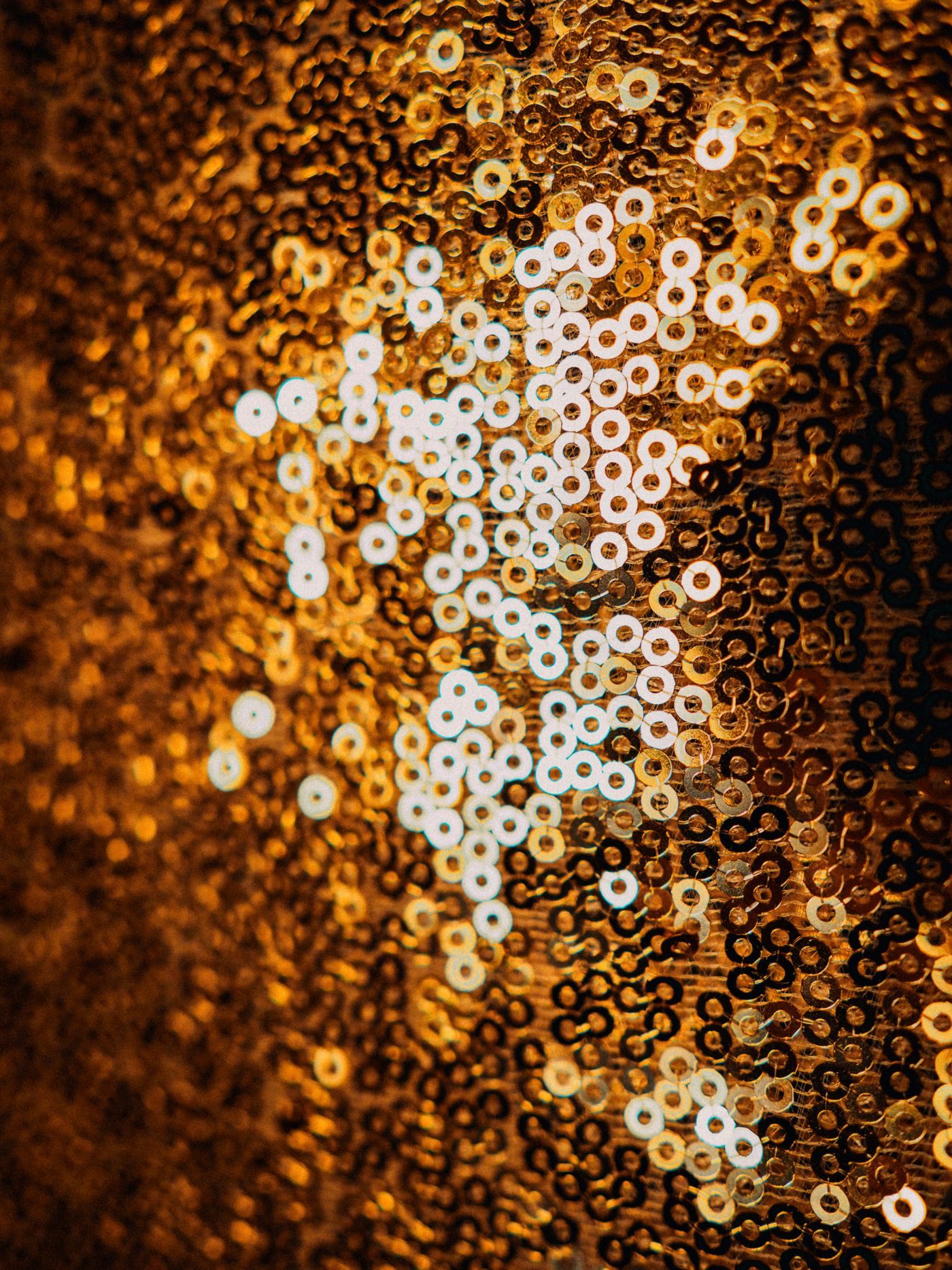 Close-up of glimmering golden sequins creating a vibrant abstract pattern