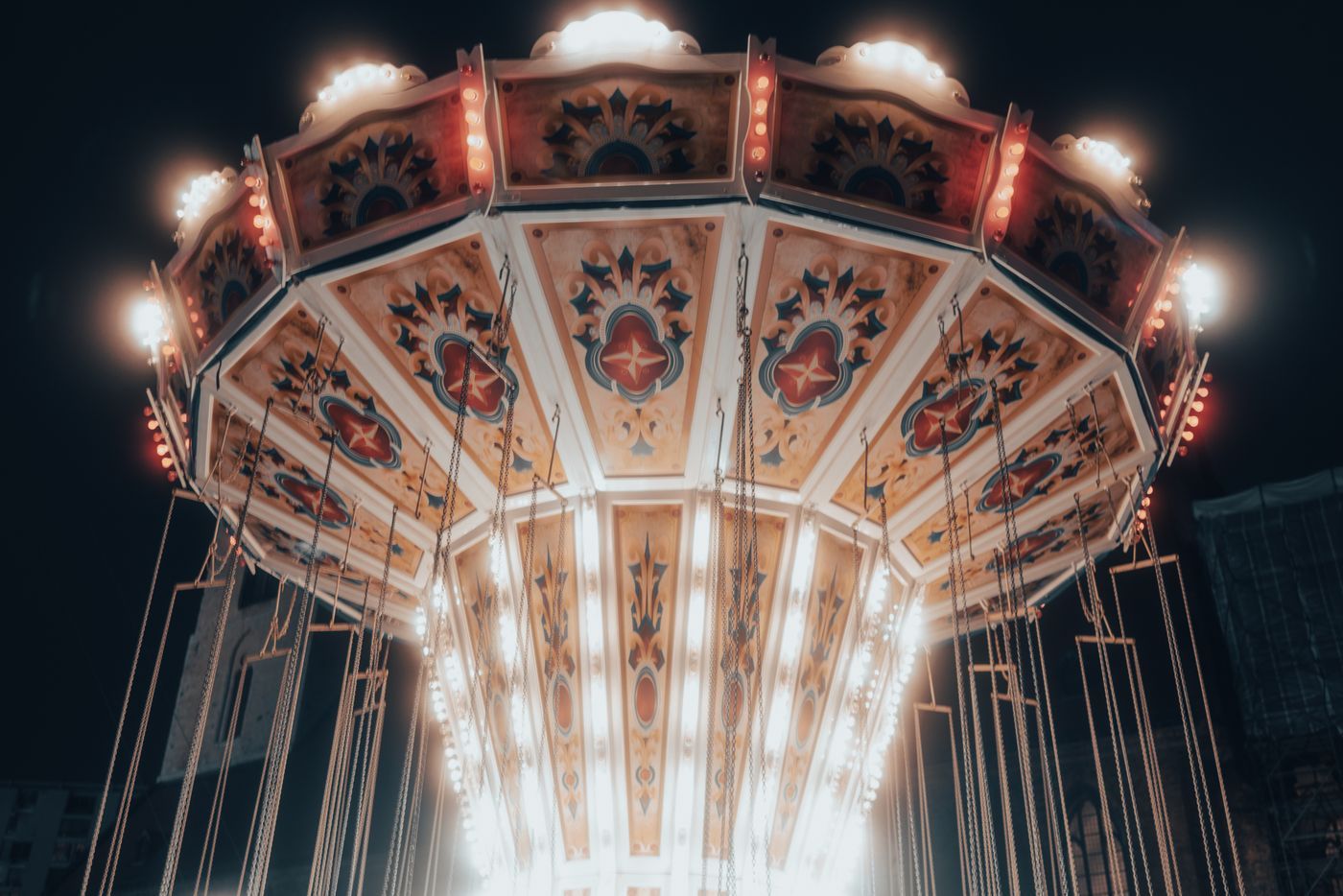 A vibrant carousel lit up at night in Berlin, showcasing colorful lights and intricate designs