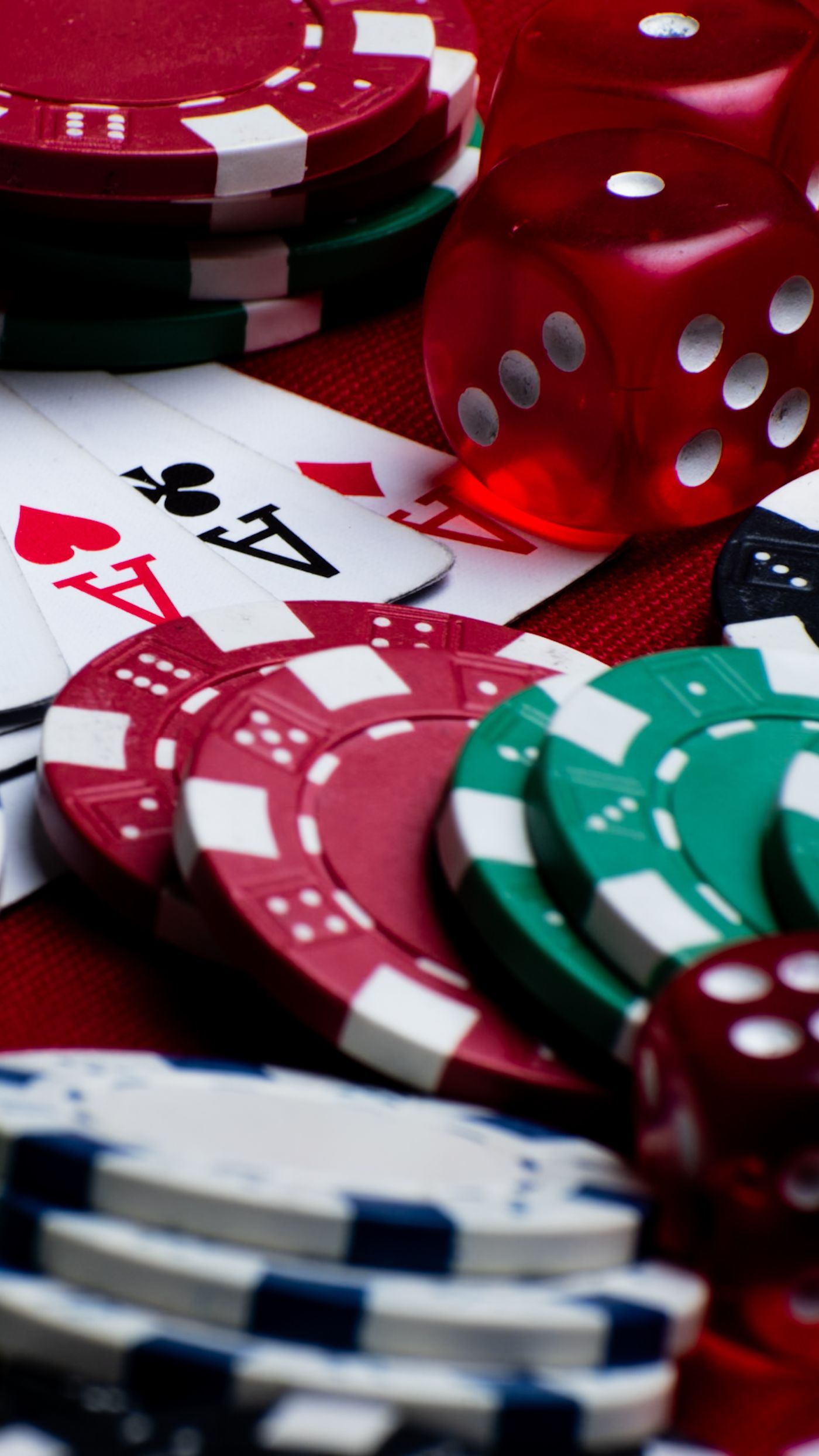 Colorful assortments of poker chips, dice, and playing cards create a vivid casino scene