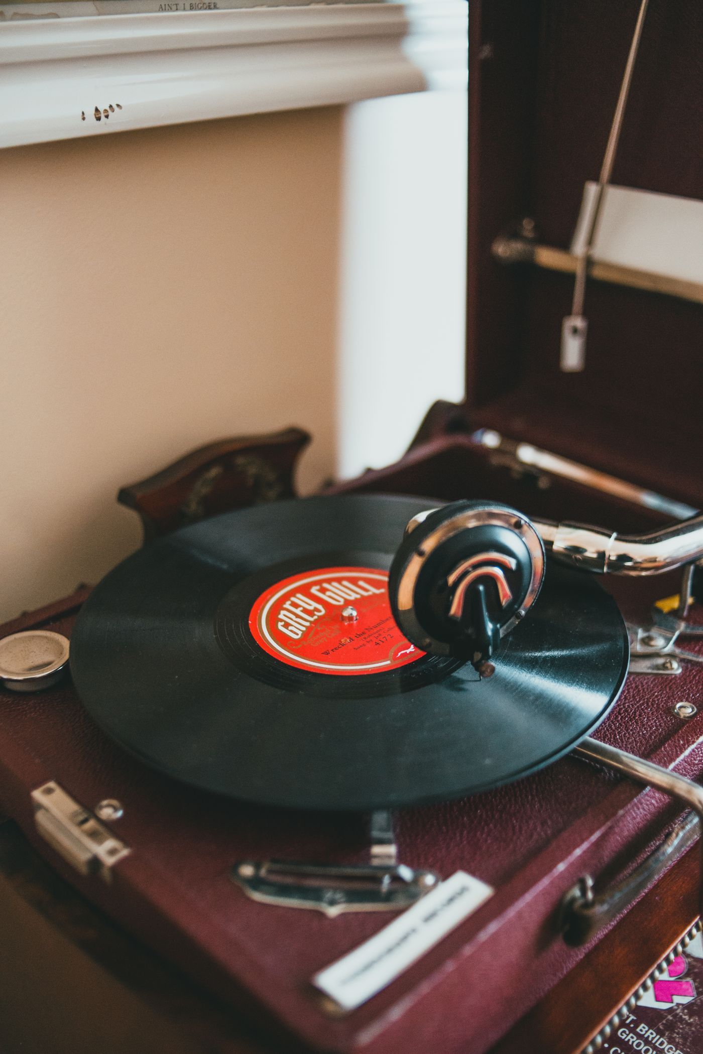 Close-up of a vintage vinyl record player with album spinning indoors. Classic analog music setup
