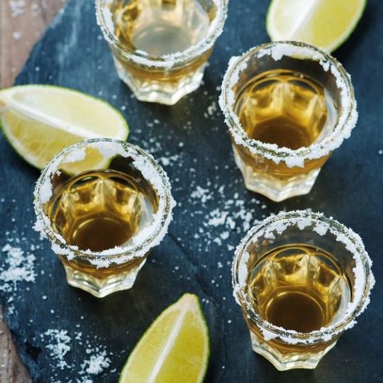 Gold tequila with lime and salt, selective focus