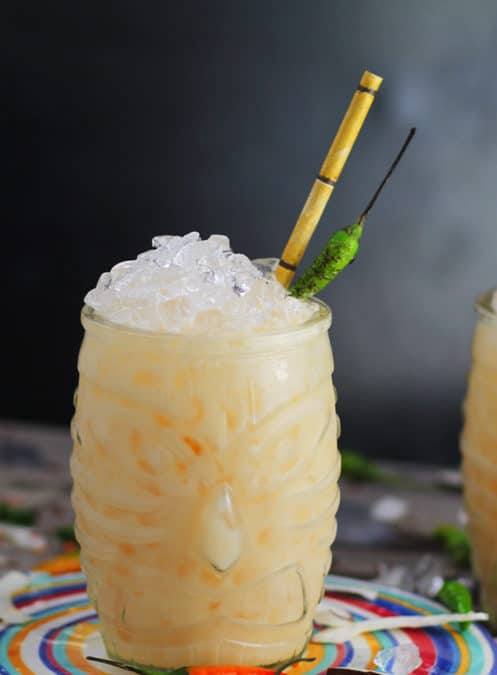 pina colada cocktail in a tiki glass and a bamboo straw.
